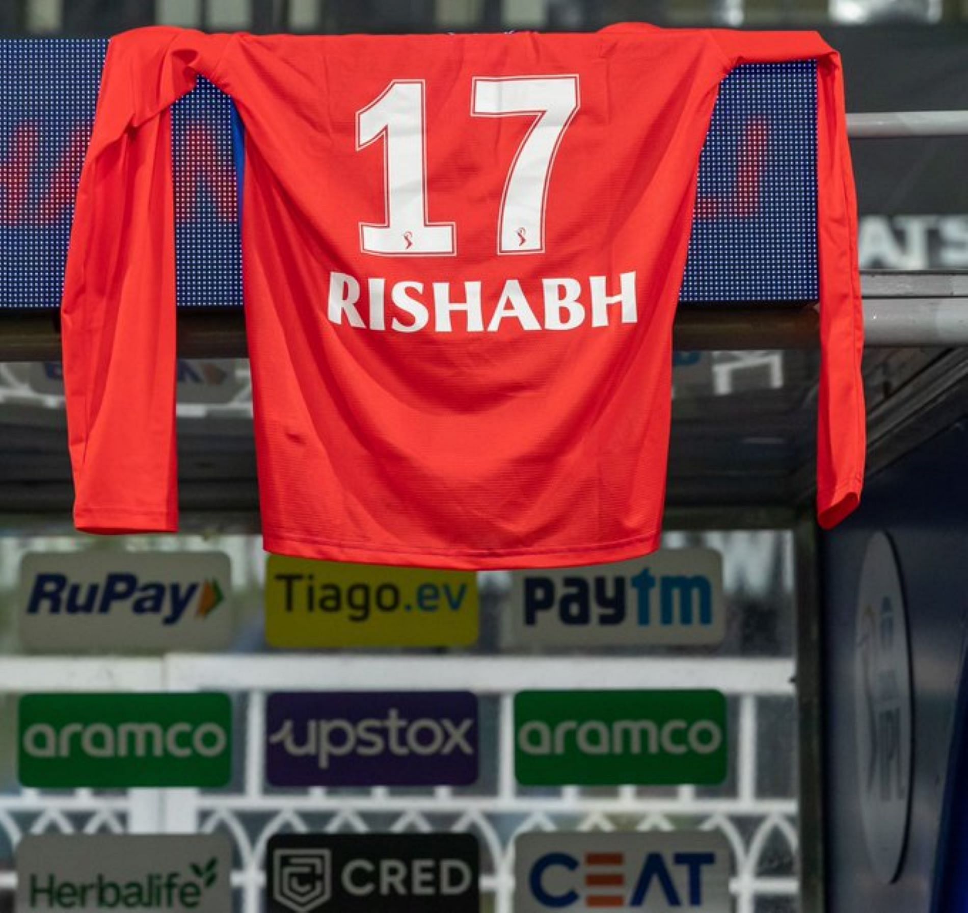 Rishabh Pant's jersey hangs above the Delhi Capitals dugout during their opening match.